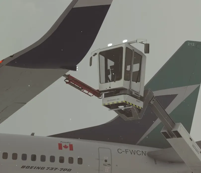 Deicing truck bucket raised at the tail of a Boeing 737 in falling snow